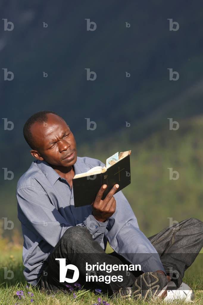 Man reading the bible outside. Saint-Gervais France