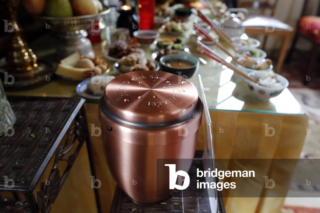 Tu An Buddhist temple. Ancestor altar. Vegetarian offerings and funeral urn. France.