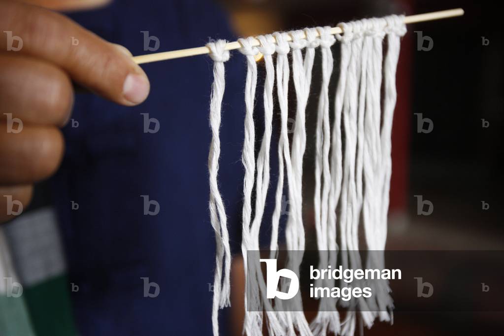 Lao buddhist ceremony with cotton bracelets, Paris, France