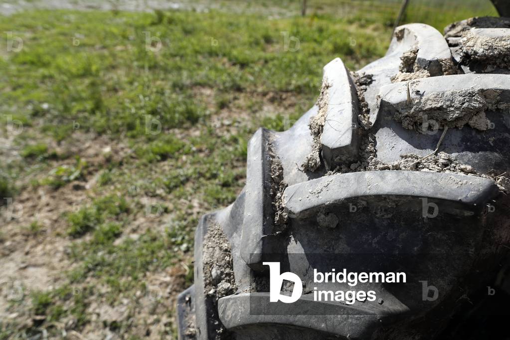 Tractor wheel in a field.  France.