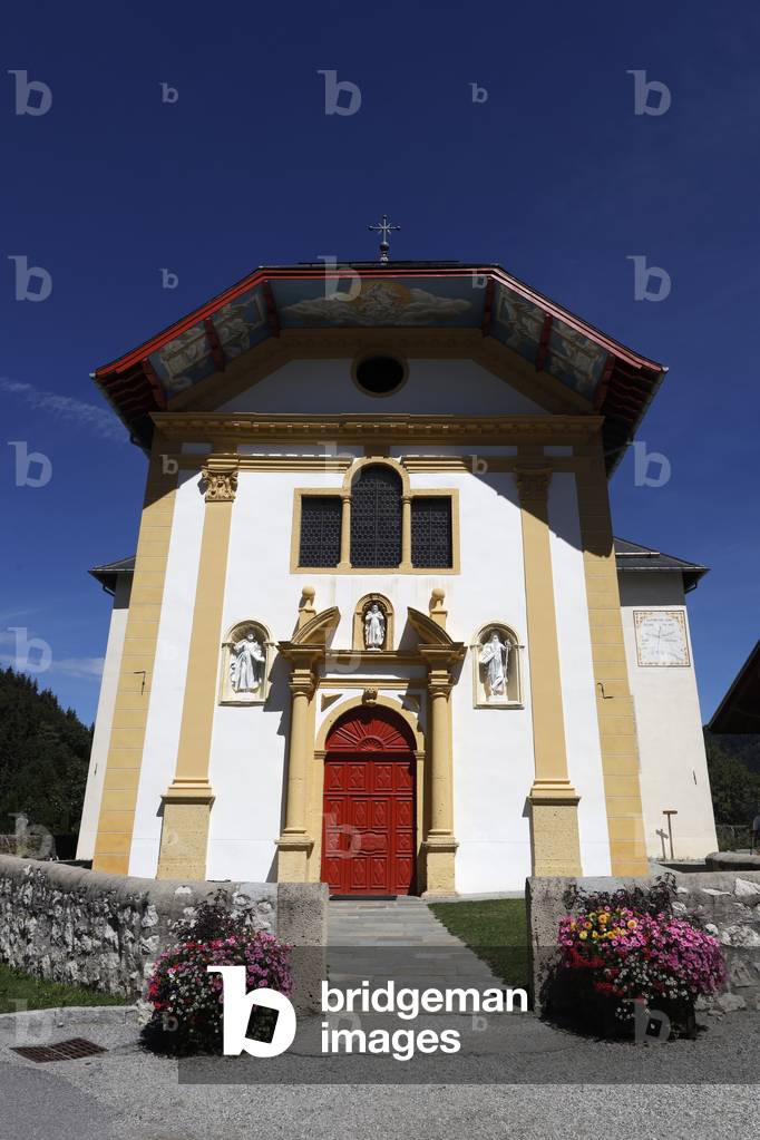 Colourful flowers in the village of Saint Nicolas de Veroce in the French Alps. The baroque church.  France.