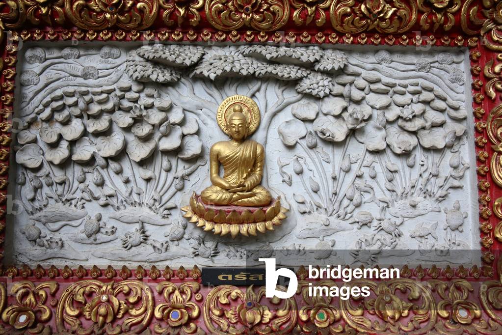 Relief depicting a scene of the Buddha's life in Wat Chai Mongkhon, Chiang Mai. Meditating Buddha. Thailand (photo)