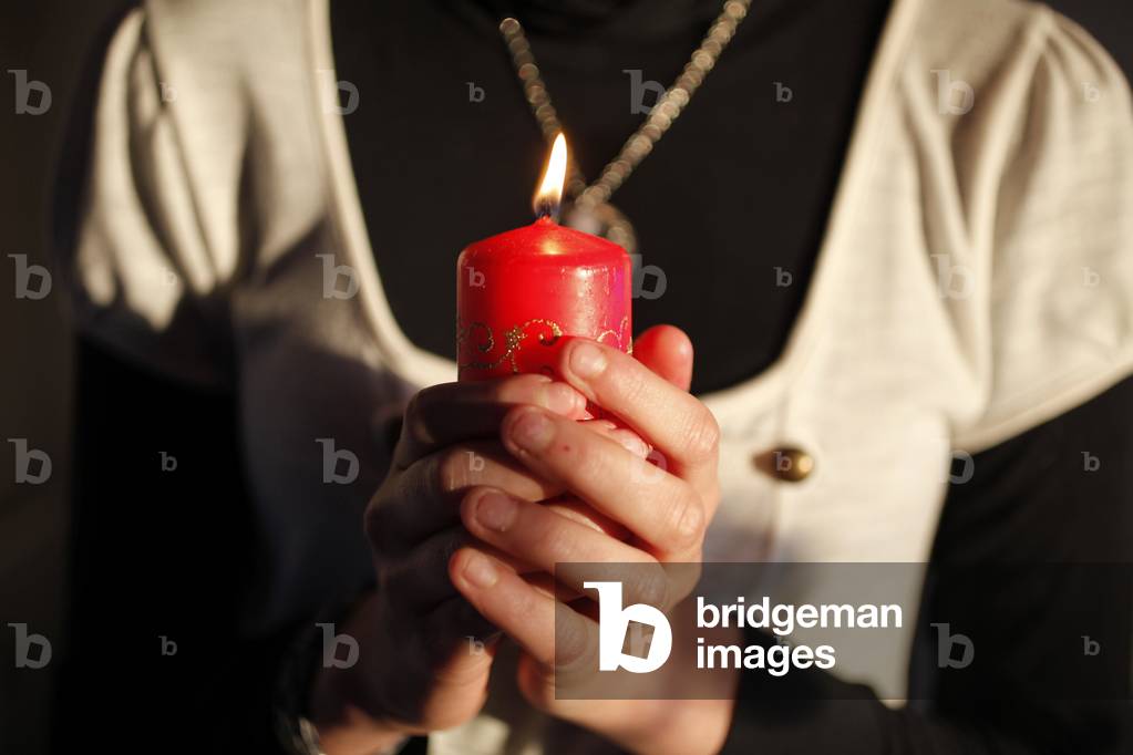 Girl holding a Christmas candle Montrouge France