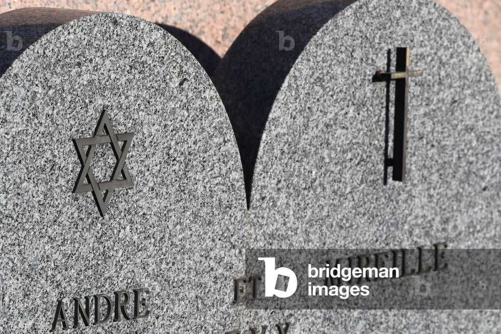 All Saints Day in a cemetery. Jewish and catholic graves in cemetery. France.