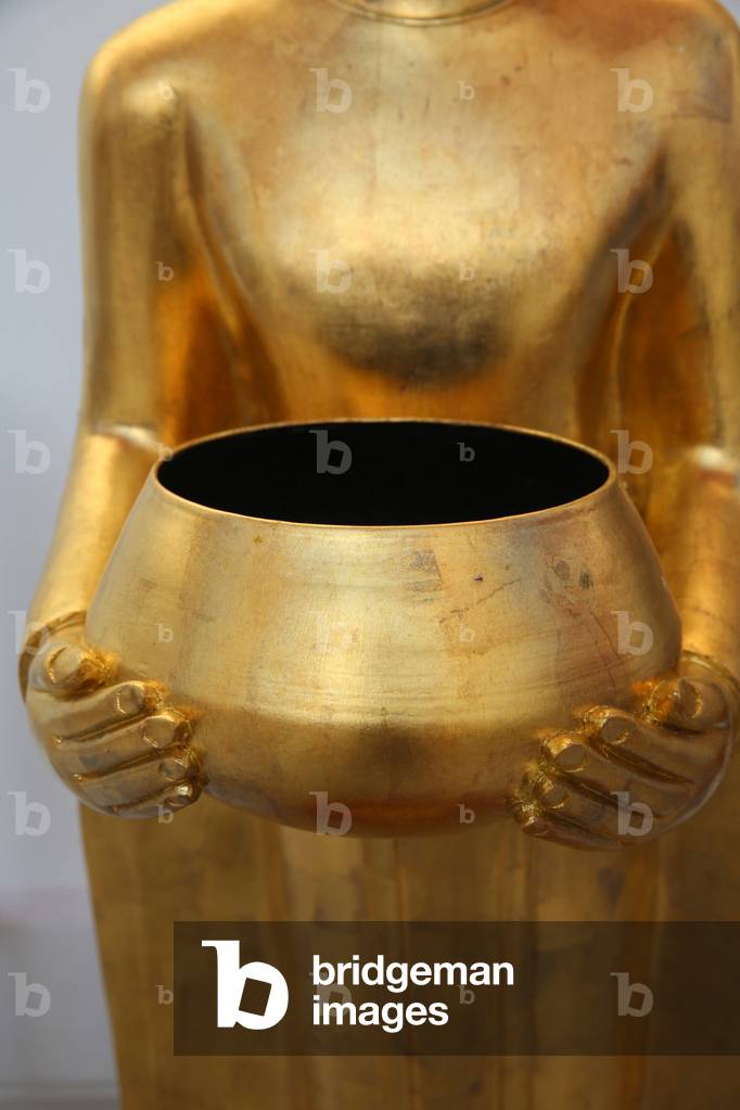 Wat Pathumkhongkha Ratchaworawiharn, Bangkok. Detail of a statue depicting a Buddha with alm bowl. Thailand