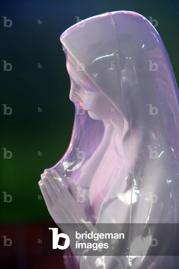 Shop selling religious christian items. Holy Virgin statue. Ho Chi Minh City. Vietnam