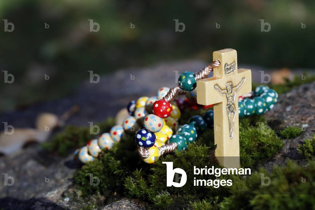 Catholic church. Wooden rosary with autum leaves.  France.