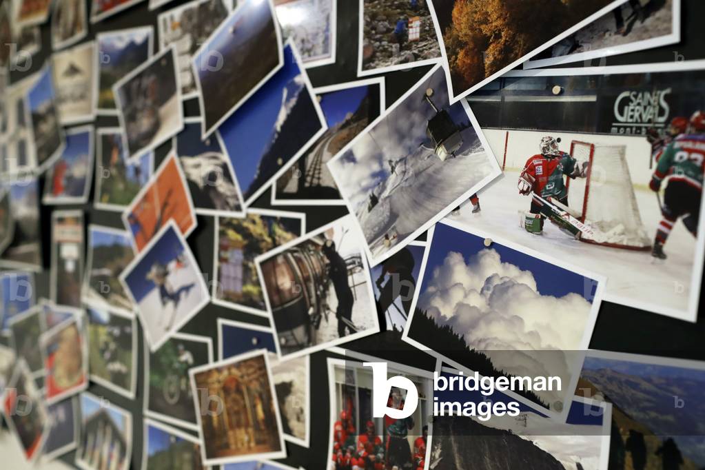 Close-Up Of Various Photographs Hanging On Wall, France (photo)
