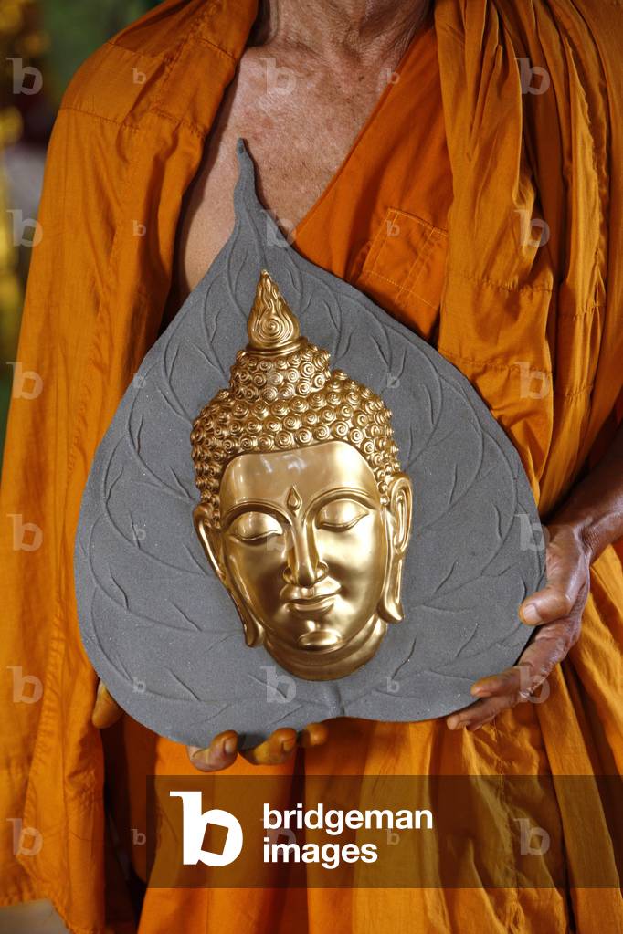 Buddhist monk visiting a Buddha statue shop, Phnom Penh, Cambodia