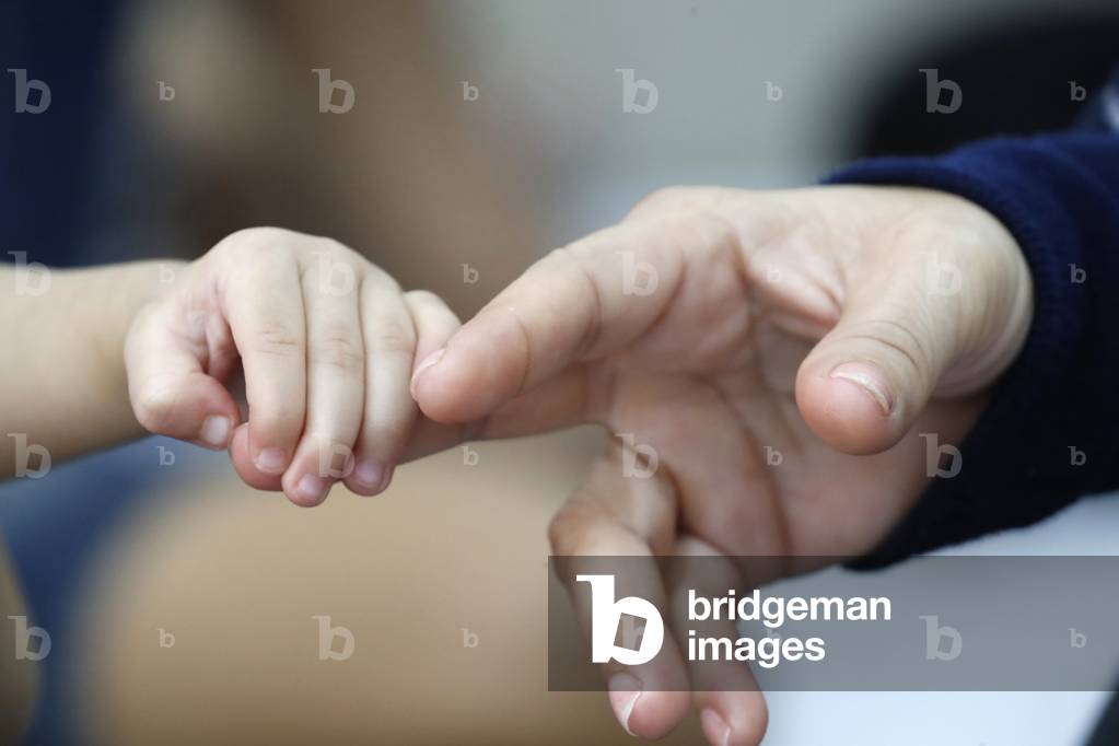 Father and son, Close-up on hands, Ho chi Minh city, Vietnam (photo)