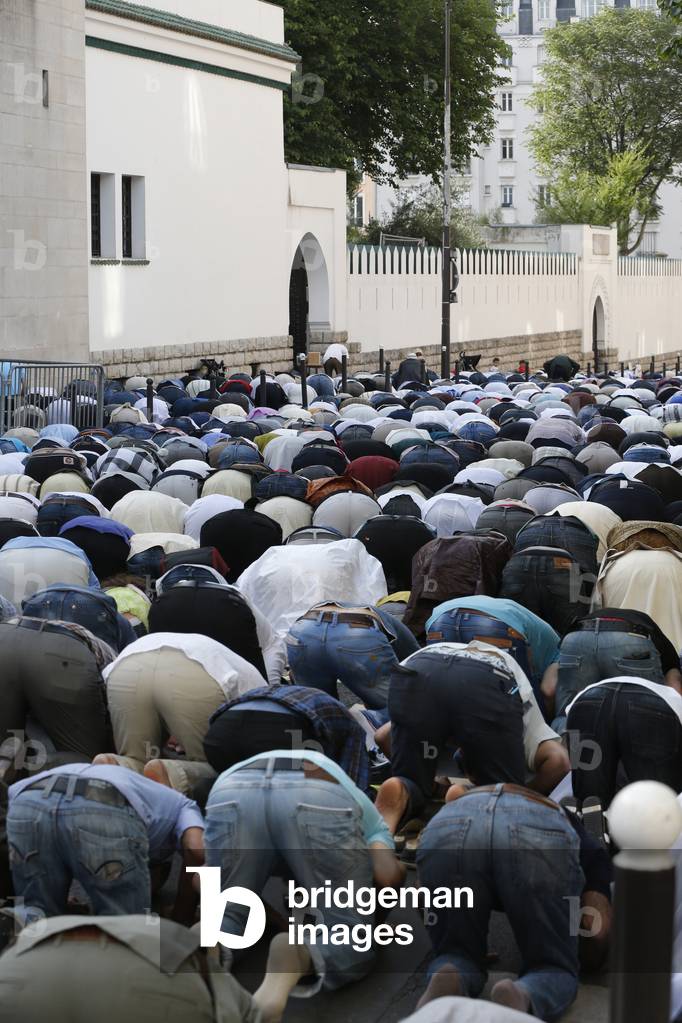 Muslims praying outside the Paris Great Mosque on Aid El-Fitr festival, Paris, France