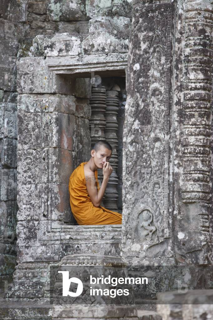 Monk at the Bayon temple, Angkor thom complex, Siem Reap, Cambodia