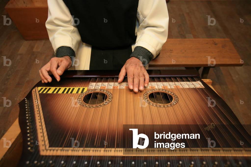 Monk playing medieval sitar at Citeaux abbey St Nicolas les Citeaux France