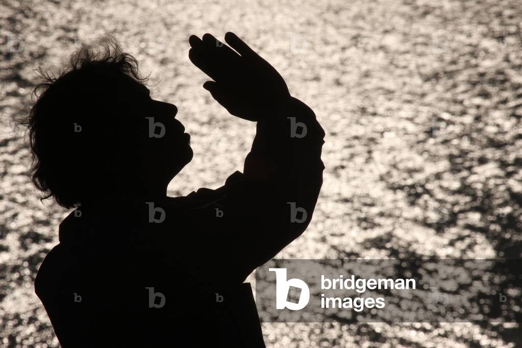 Praying at seaside, Etretat, France