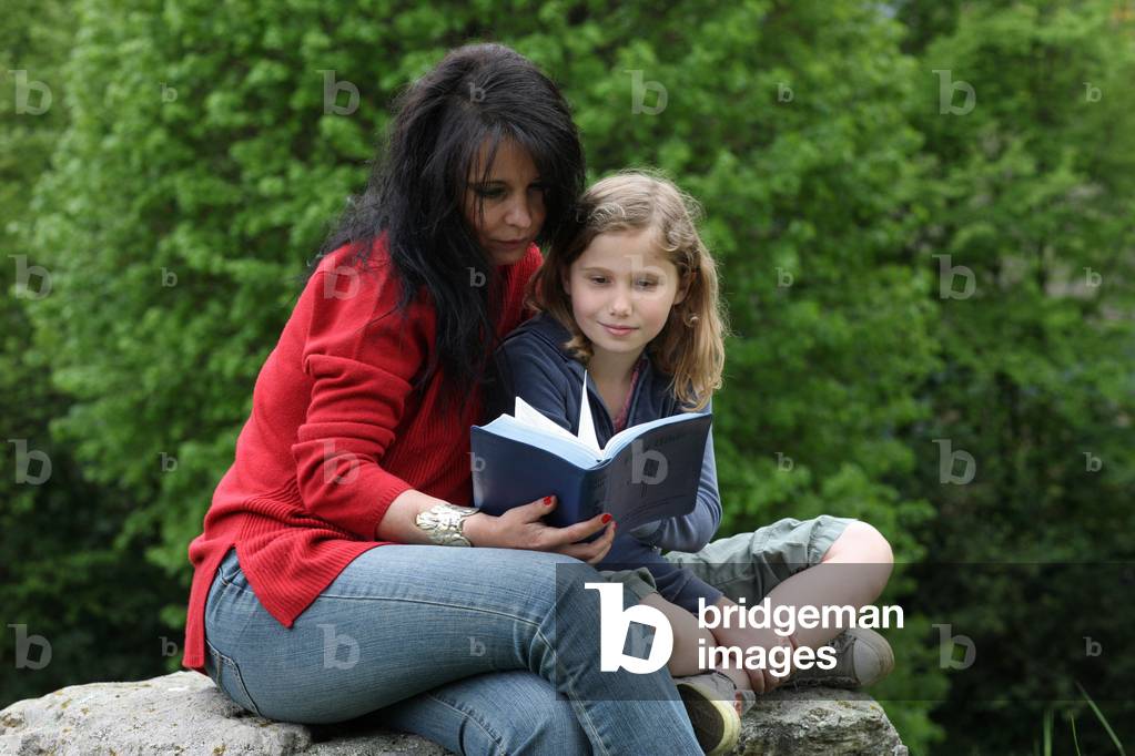 Woman and child reading the bible. Saint-Gervais France