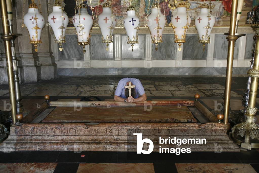 Worshipper at the Stone of the Anointing. Church of the Holy Sepulchre, Jerusalem, Israel