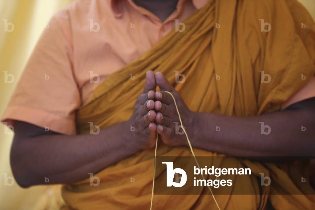 Geneva, Geneva, Switzerland, le 11/7/2015 - International Buddhist Center of Geneva. Buddhist ceremony. Monk praying. Sai-Sin (sacred thread) in use.