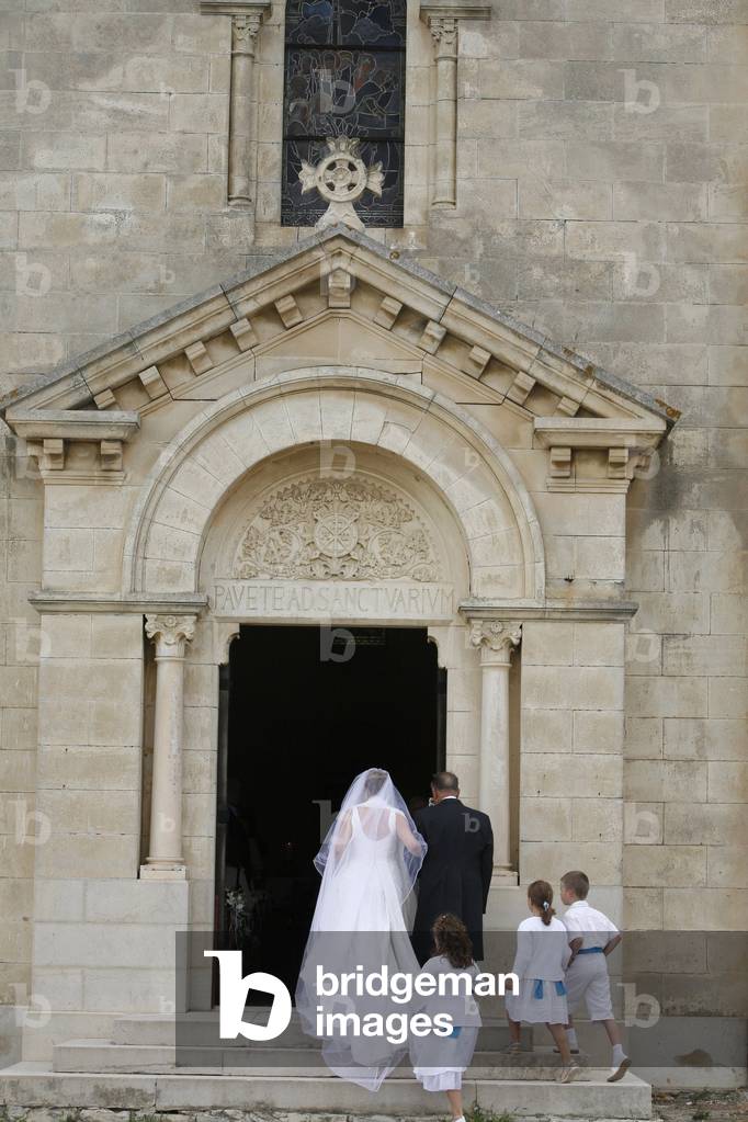 Bride walking into church, Montcalm, France