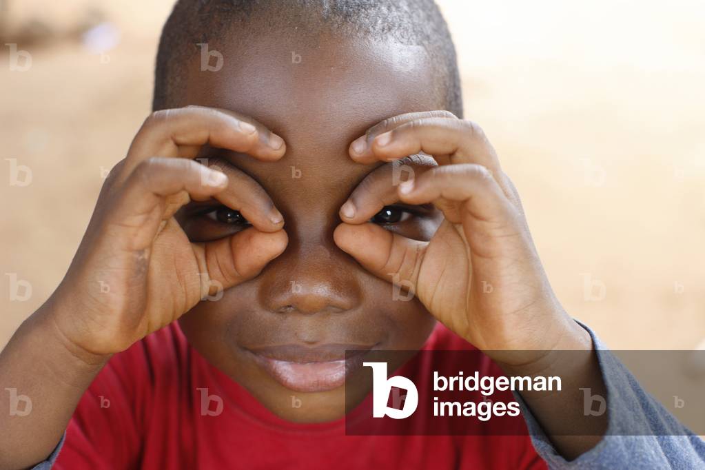 Young boy playing with his fingers, Lome, Togo