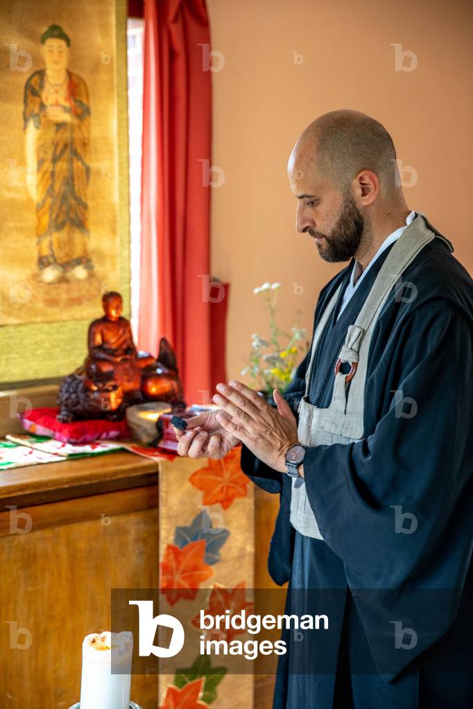 Zen sesshin (retreat) at La Trappe abbey, Soligny-la-Trappe, France.   Master performing a ritual. (photo)