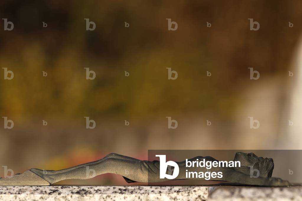 All Saints Day in a cemetery. Crucifix. Jesus on the cross.  France.