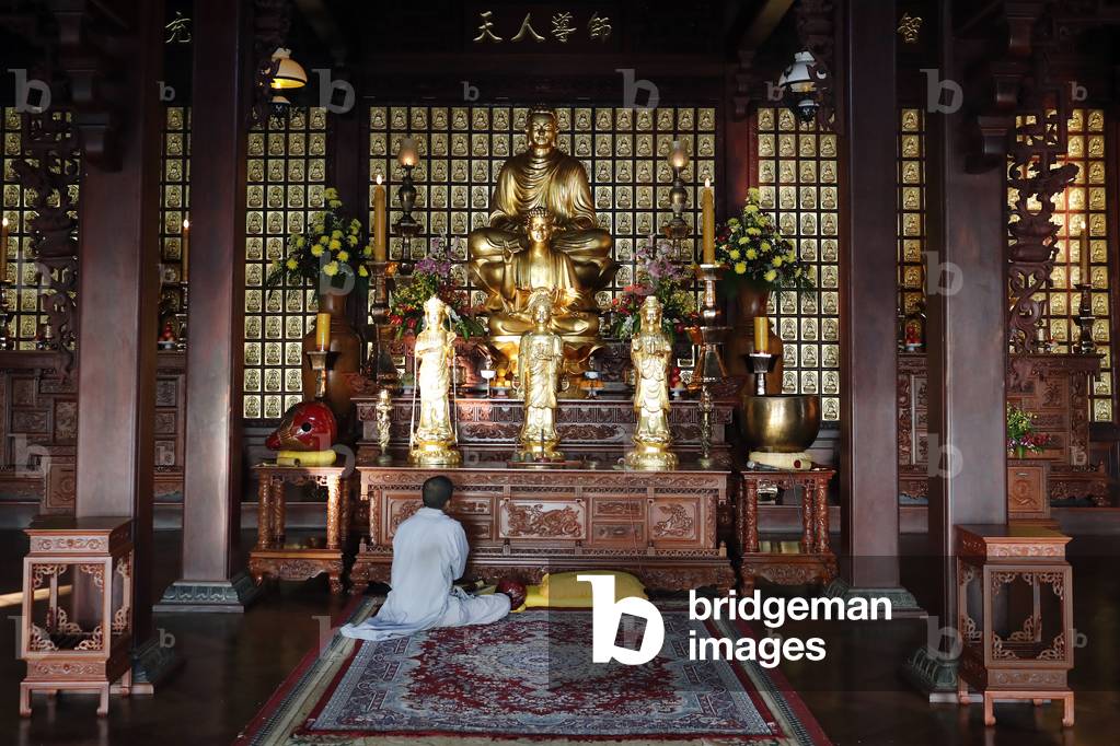Khai Doan King Honored Pagoda, Man praying, Buon Me Thuot, France, 2019 (photo)