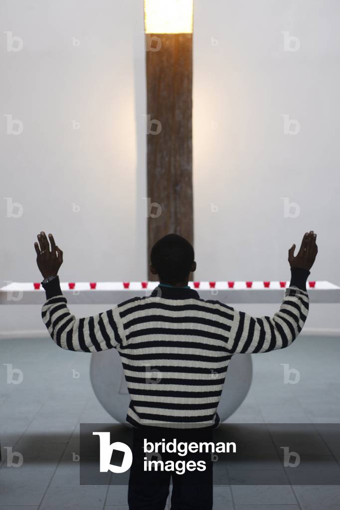 African man in a church, Paris, France