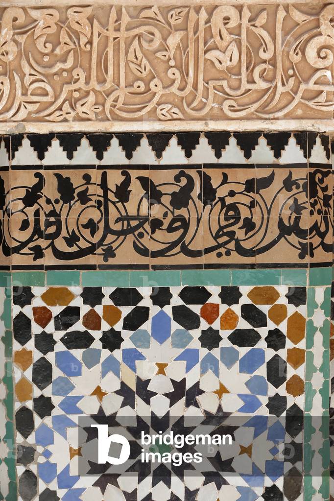 Ben Youssef Medersa is the largest Medersa in Morocco, Originally a religious school founded under Abou el Hassan, Calligraphy and zellij in the patio, Marrakech, Morocco