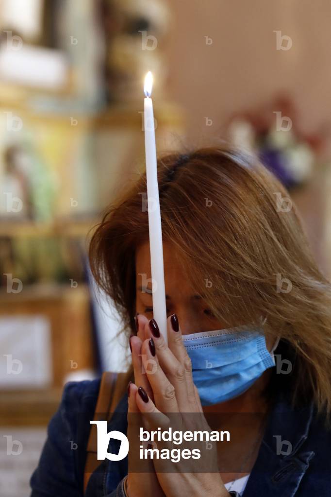 Catholic woman praying in church.  France.