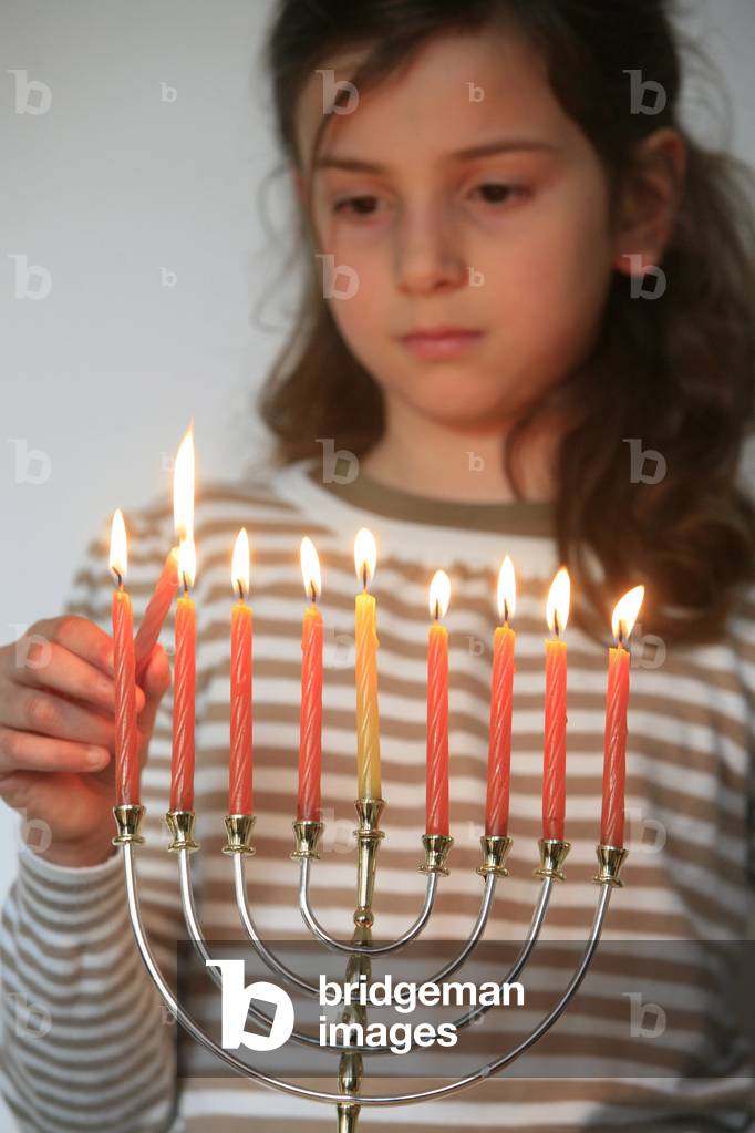 Girl lighting Hannuka candles Montrouge France