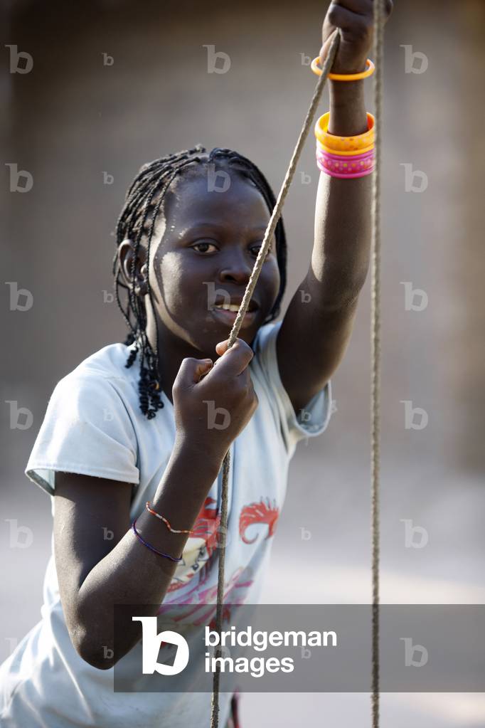 Girl fetching water from a well, Kafountine, Senegal