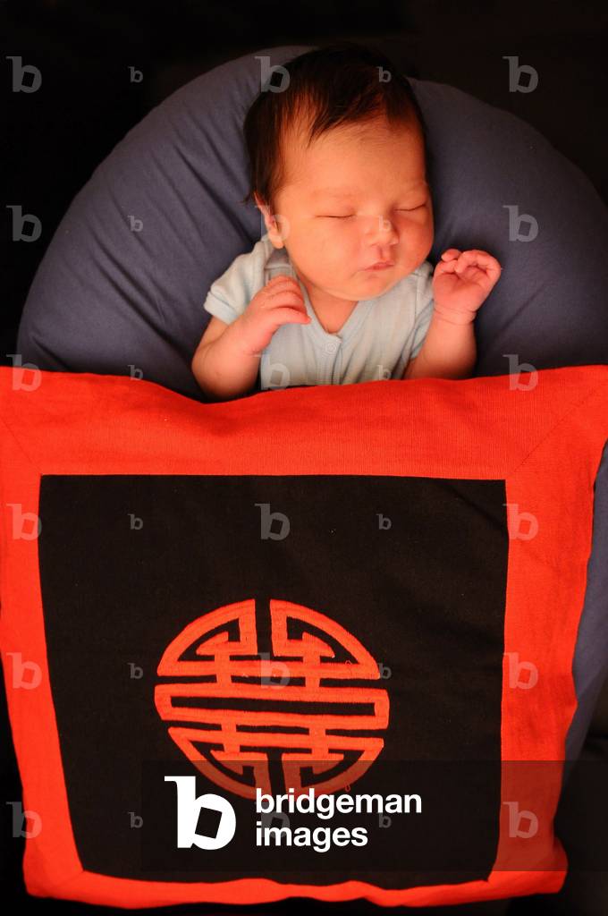 Asian baby with long life symbol, Paris, France
