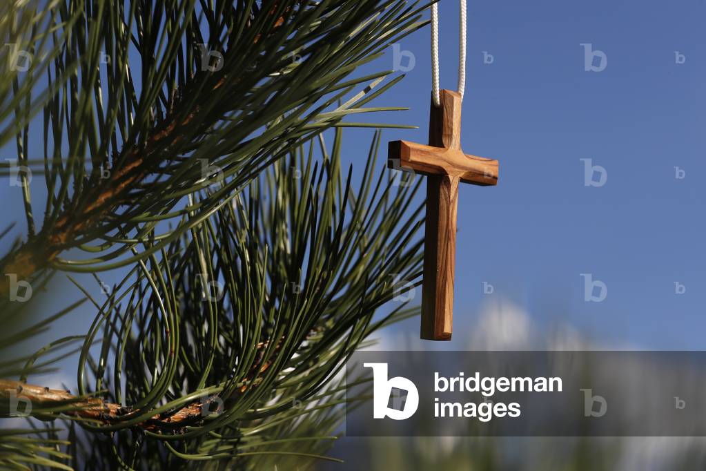 Christian wooden  cross on  fir tree branches.  France.