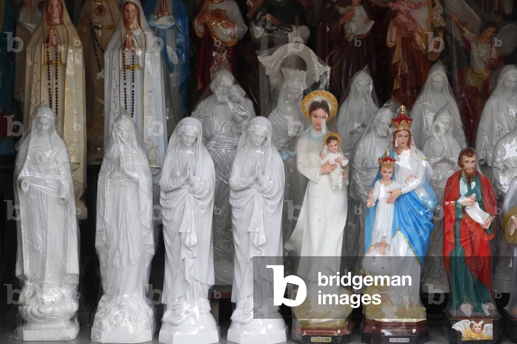 Shop selling religious christian items. Holy Virgin statues. Ho Chi Minh City. Vietnam