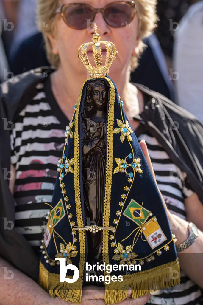 A Brazilian woman holds an Our Lady of Aparecida statue during Pope Francis's Holy Mass on the occasion of the Migrant and Refugee World Day, in St. Peter's Square, at the Vatican.