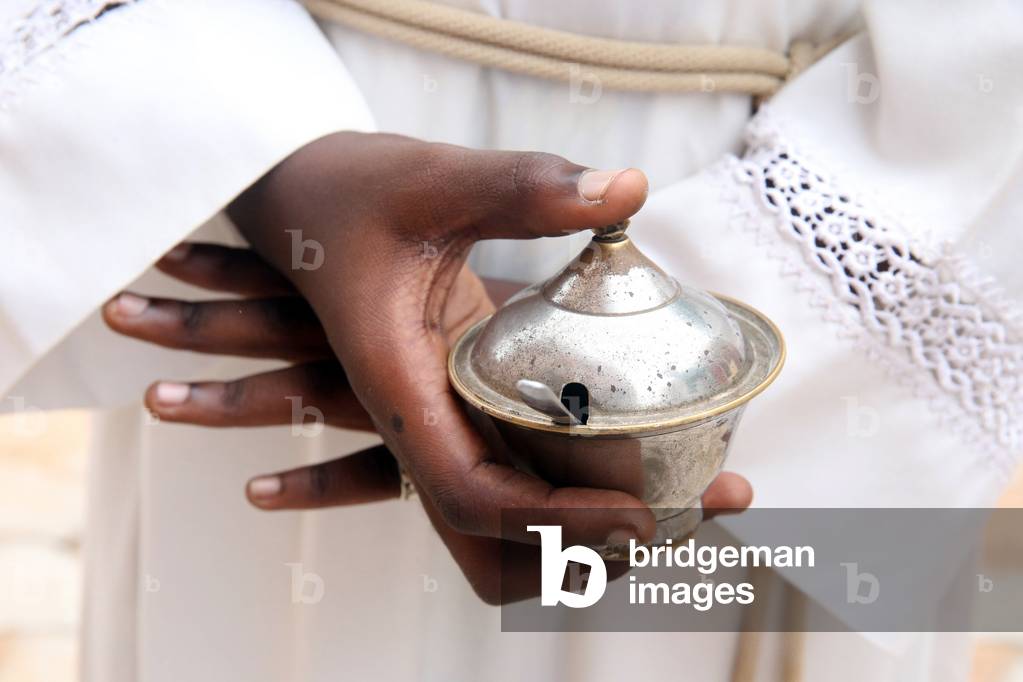 Altar boy with incense for Holy Mass. Close-up. Lome. Togo