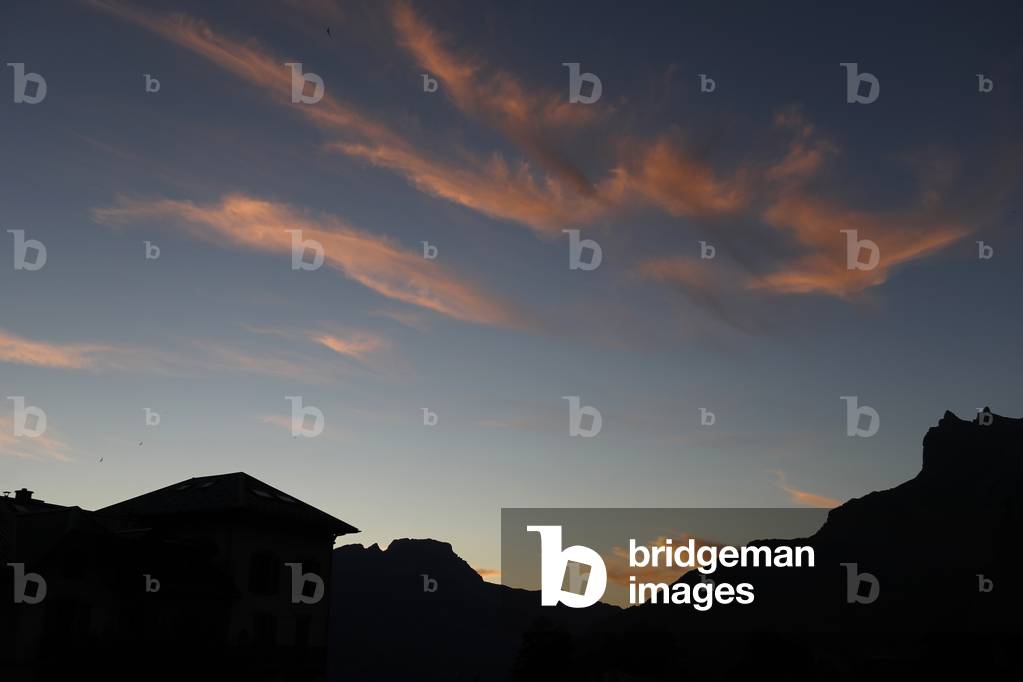 Saint Gervais, Varan mountain and orange clouds.  France.