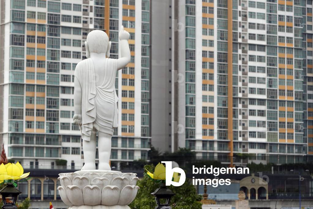 Minh Dang Quang buddhist temple.  Boy Buddha statue with long-ears, bald-headed and one finger pointing to the sky.  Ho Chi Minh city. Vietnam.  (photo)