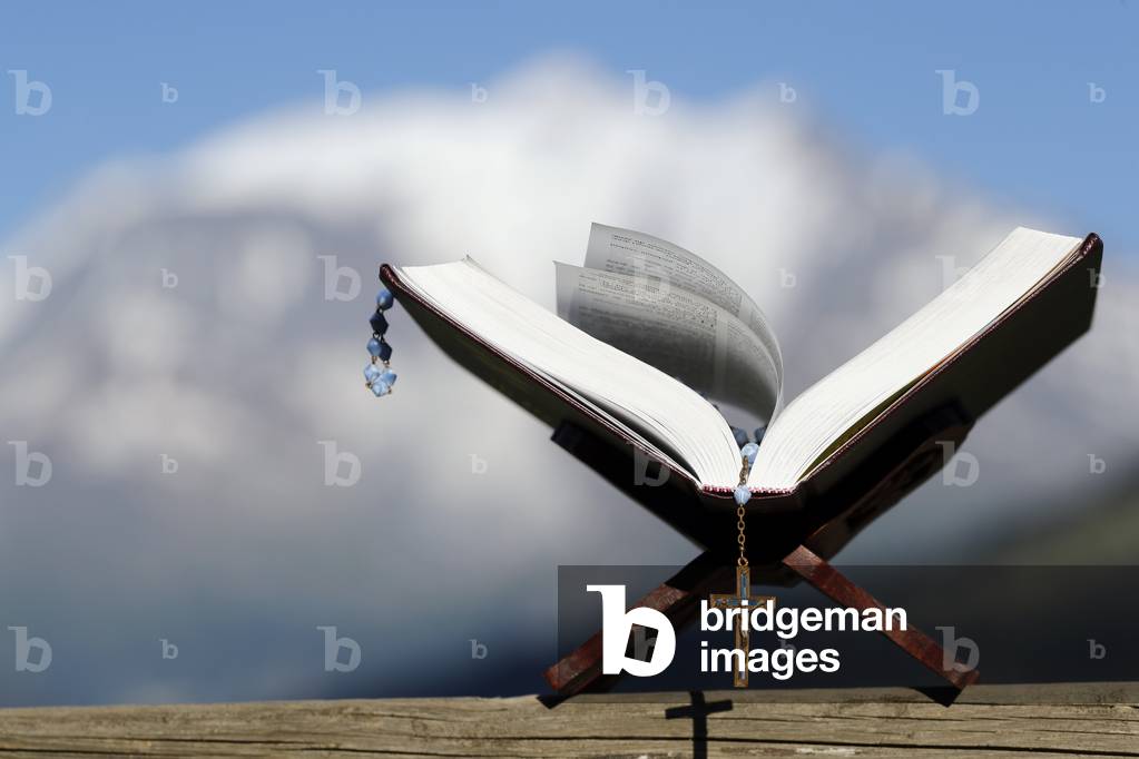 Mont Blanc massif.  Bible and rosary on a bench.  Combloux. France.