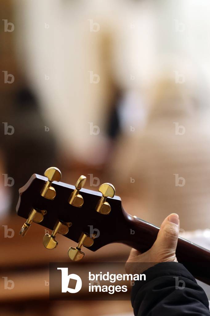 Catholic mass. Guitar player. Close-up on hand.  Saint Francois de Sales church.  Annecy. France.