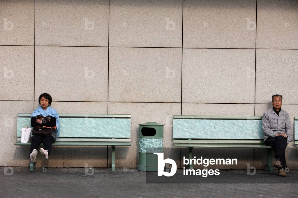 Tung Chung district. Young woman and old man. Tung Chung China