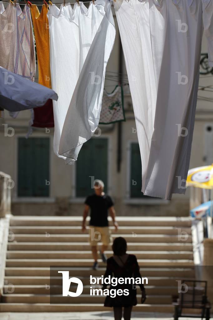 Silhouette of a woman  walking on outdoor stairs.
