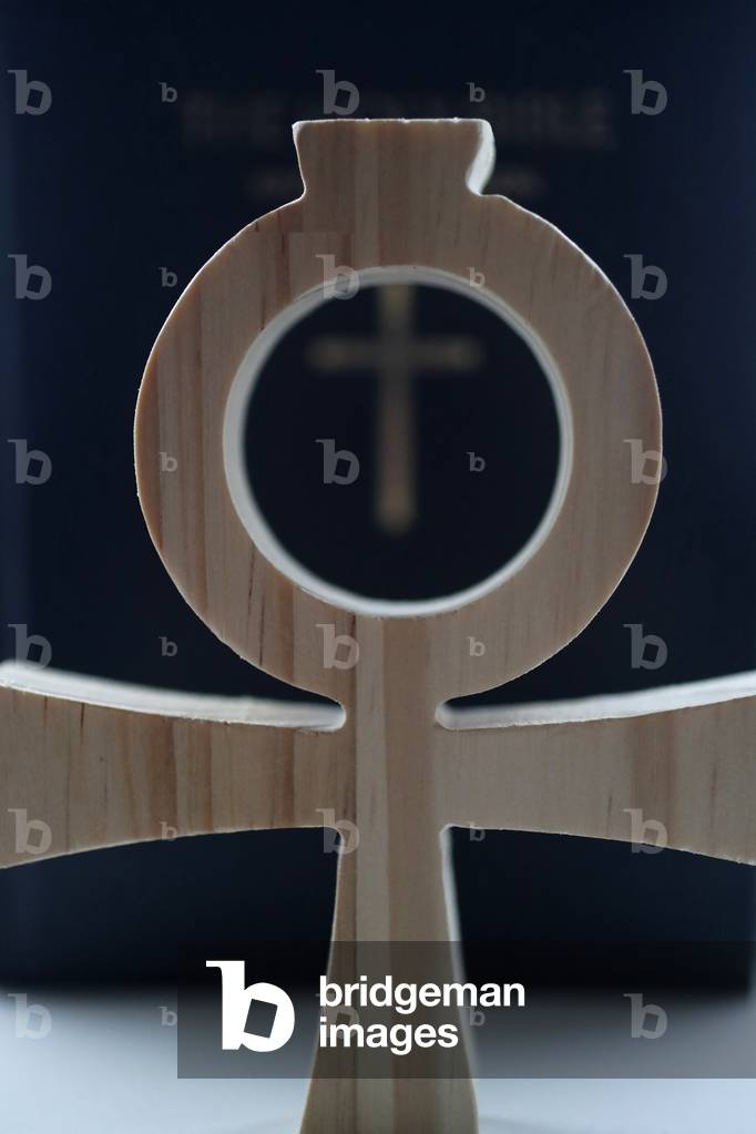 Bible and the Ankh, symbol from ancient Egypt, known as the key of life or the cross of life, The ankh as a form of the Christian cross, symbolizing eternal life through Christ (photo)