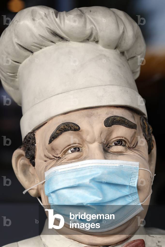 Restaurant. Mannequin with surgical mask.  Geneva.  Switzerland.