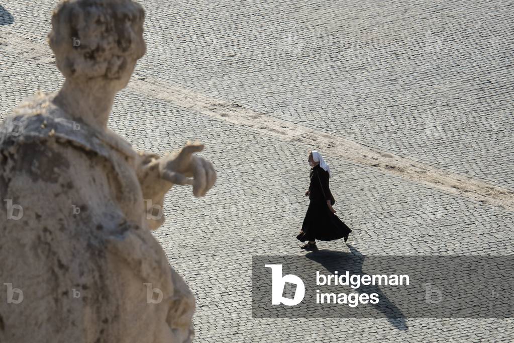 A nun walking in the deserted St. Peter’s square, as the Pope holds a limited public audience at the San Damaso courtyard instead of St. Peter's square in The Vatican on September 30, 2020 during the COVID-19 infection, caused by the novel coronavirus.