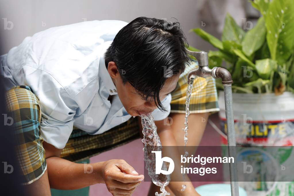 Cholon Jamail Mosque, Muslim performing ablution prior to Salat, Ho Chi Minh City, Vietnam, 2019 (photo)