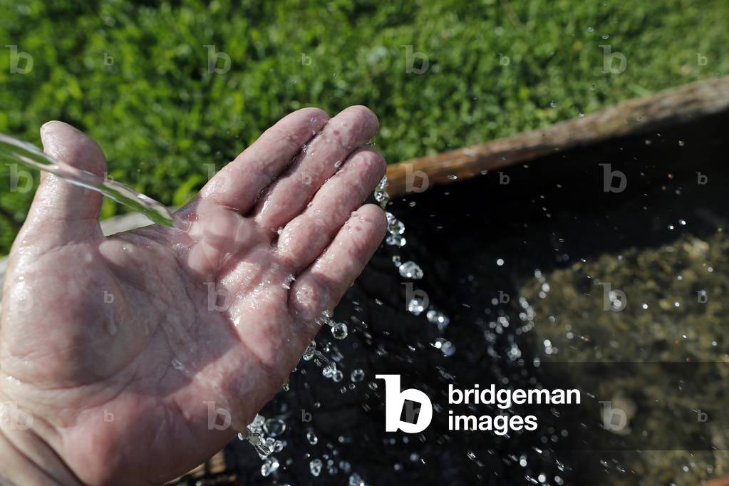 Fountain with fresh mountain water, Close-up on hand, Saint-Gervais, France, 2019 (photo)