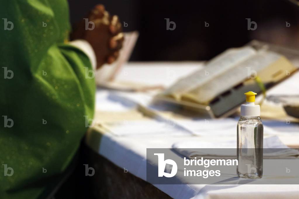 Catholic church during covid-19 epidemic. Sunday mass. Priest at eucharistic celebration.  France.