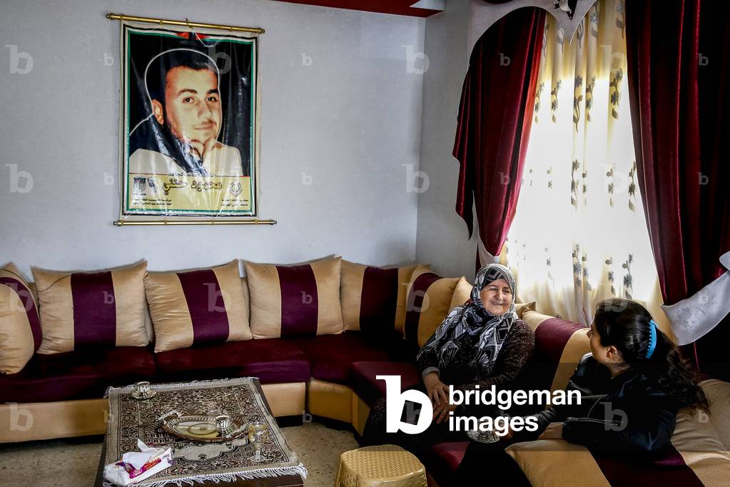 Mother of a Palestinian fighter who died during a terrorist attack in a jewish settlement in her home with a guest, 2018 (photo)