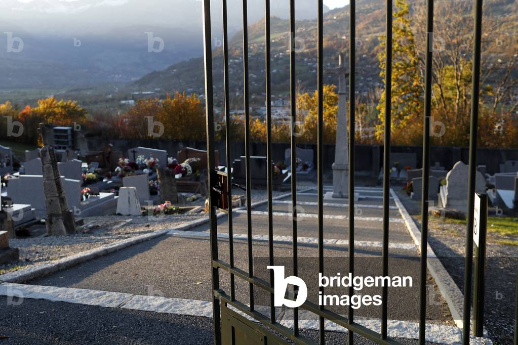 All Saints Day in a cemetery. Main gate.  France.